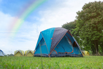 The Colorful Camping Tent with rainbow in the summer at forest.