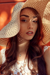 Fashion portrait of young stylish hipster woman walking on the street, wearing trendy outfit, straw hat, travel.