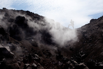 Silhouette of a man taking a photo through volcanic steam, Anak Krakatoa, Indonesia