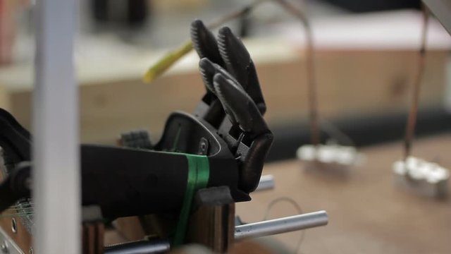 Close up of artificial hand limb is being tested. Concept: prosthesis, artificial limb, future technology, medicine.