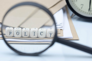 The concept of policies. Words use blocks of wood on files and documents. Selective Focus.