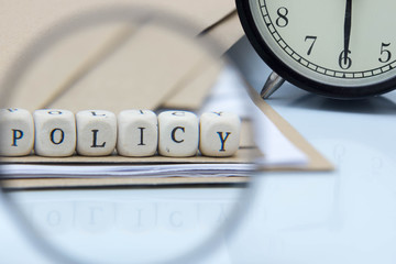 The concept of policies. Words use blocks of wood on files and documents. Selective Focus.