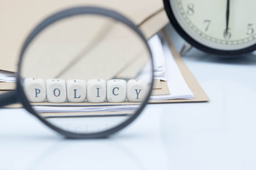 The concept of policies. Words use blocks of wood on files and documents. Selective Focus.