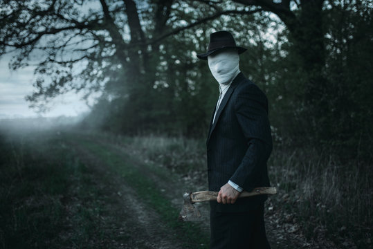 Serial maniac with axe in forest, bloody killer