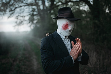 Maniac with axe, face wrapped in bloodied bandages