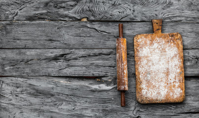 old kitchen wooden board with flour on a rustic table