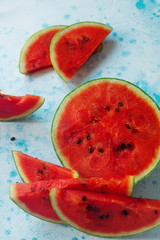 Fresh organic watermelon sliced on light blue bakground. Selective focus
