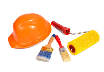  orange building helmet, paintbrush and roller for paint on a white background
