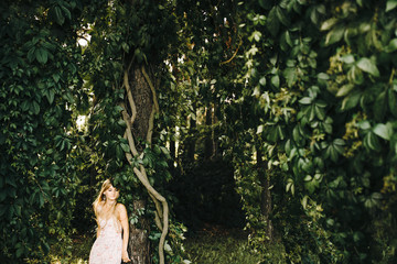 Beauty Girl Outdoors enjoying nature. Beautiful Teenage Model girl with long healthy blowing hair , Sun Light. Glow Sun. Free Happy Woman. Toned in warm colors