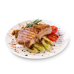 Plate of grilled steak meat with vegetables on white background