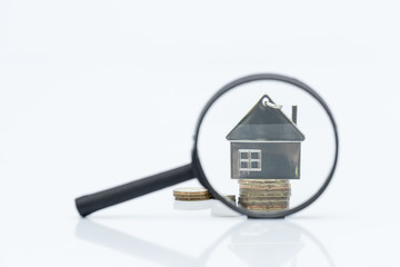 magnifying glass, home key chain and coin for home search concept