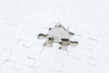 concept site or home area, key chain shape home in the middle of the puzzle