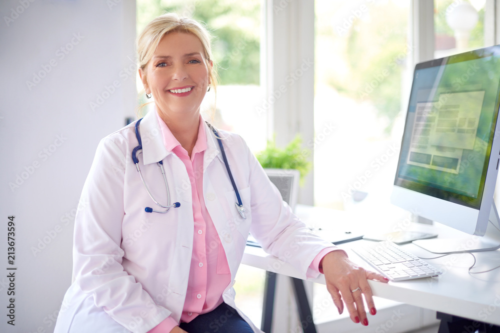 Wall mural Female doctor portrait at the medical room