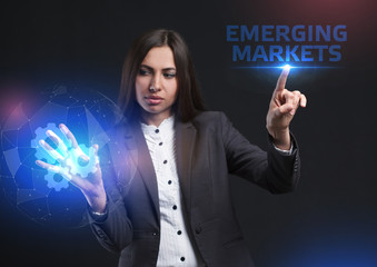 The concept of business, technology, the Internet and the network. A young entrepreneur working on a virtual screen of the future and sees the inscription: Emerging markets