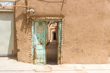 An authentic wooden self-made door on the streets of old town in Yazd, Iran. Arabic number 3 on the...
