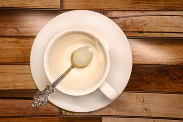 Fototapeta na wymiar white cup on a saucer on a wooden background