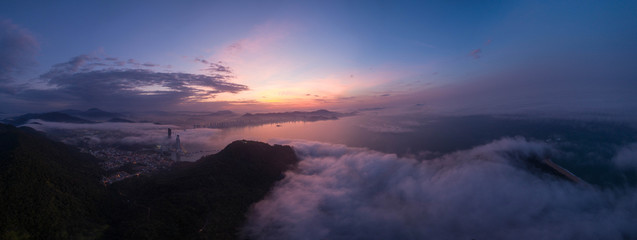 Aerial view of Camboriu Bay (Brazil) under dusk and partially under fog
