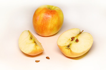 juicy and ripe apples and slices on a light background