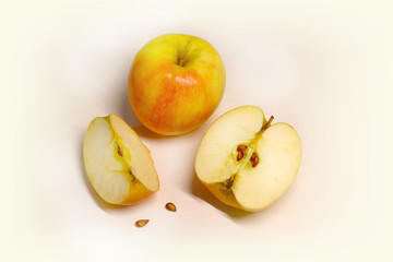 Naklejka na ściany i meble juicy and ripe apples and slices on a light background