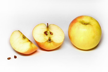 juicy and ripe apples and slices on a light background