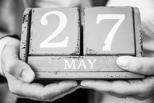 Newly Wed Couple Holding May 27 Date in their Hands