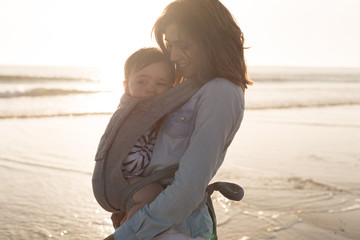 Mother carrying baby