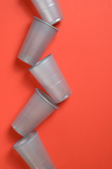 Grey Plastic Cups on Bright Orange Background, , Food Concept