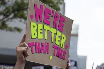 We're better than this political banner at a protest march