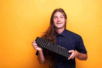 Inspiring male adult holding a keyboard