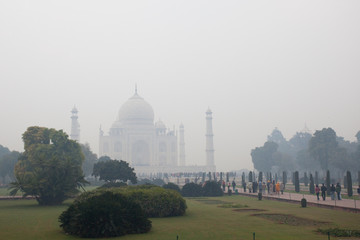 Taj Mahal and tourists on a foggy morning