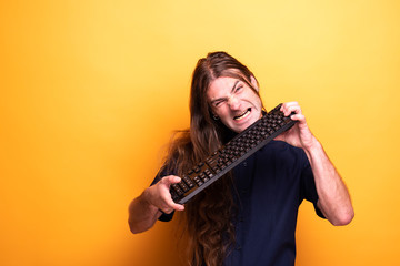 Obraz premium Adult male making funny faces with keyboard