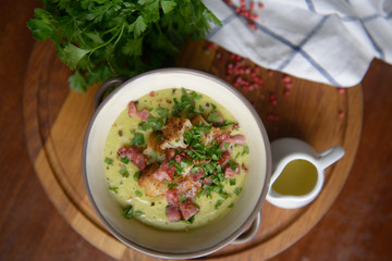 A lovely soup with croutons and ham on the table - top view
