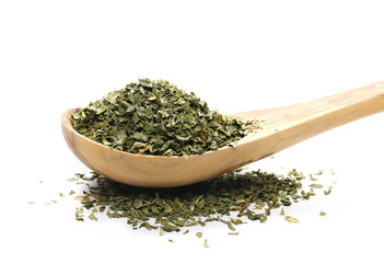 pile celery spice, dried chopped leaves in wooden spoon isolated on white 
