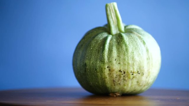 round zucchini on blue background