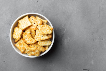 Dry salty cracker cookies on gray stone background.