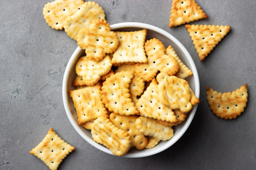 Dry salty cracker cookies on gray stone background.