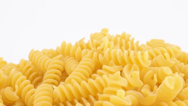 Italian fusilli pasta rotating on white background (loopable)