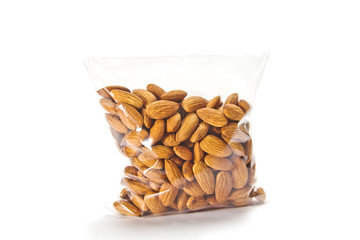 Almonds packed in plastic bag isolated on white background