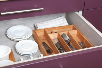 Fototapeta na wymiar Different tableware in drawer on kitchen