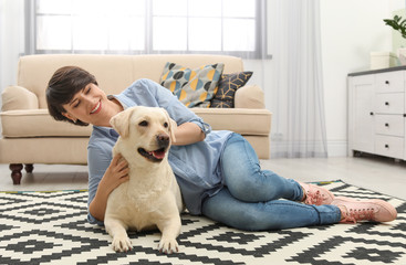 Adorable yellow labrador retriever with owner at home