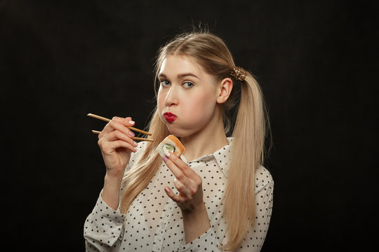 woman eats sushi