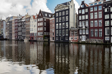 Fototapeta na wymiar Canal houses in Amsterdam reflecting in the water