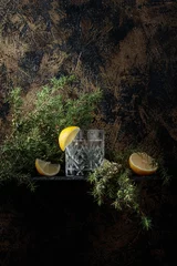 Rolgordijnen Gin , tonic with slices of lemon and a sprig of juniper . © Igor Normann