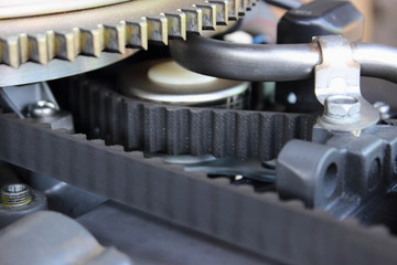 The outlet pipe of crankcase gases, the timing belt and the teeth of the flywheel closeup of...