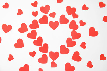 Composition made of small paper hearts on white background