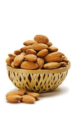Almonds in cane basket isolated on white background