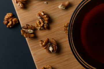 Healthy Breakfast ingredients: honey, walnuts, on a dark background. Healthy diet. Top view. Close up.