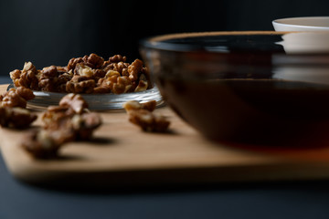 Healthy Breakfast ingredients: honey, walnuts, oatmeal on a dark background. Healthy diet. Close up.