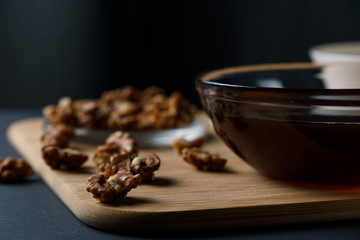 Healthy Breakfast ingredients: honey, walnuts, oatmeal on a dark background. Healthy diet. Close up.