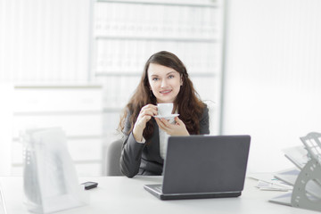 young business woman with Cup of coffee in a work break
